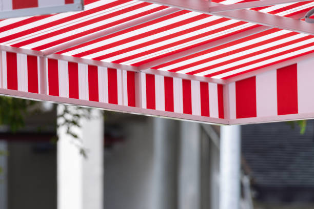 istock A red and white striped awning is above a sidewalk. 2173478742