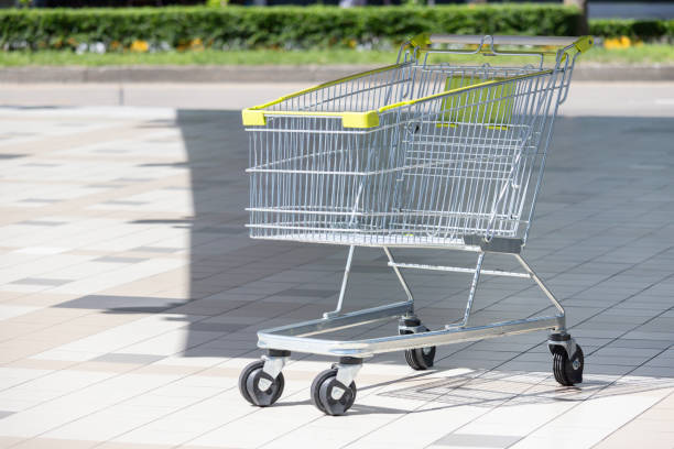 istock A shopping cart is sitting on the sidewalk 2173478780