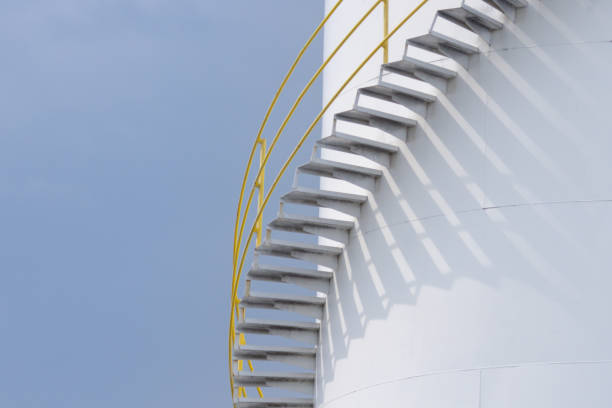 istock A white chemical tank with a yellow railing and a staircase. 2173478820