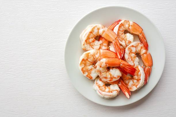 istock Boiled shrimp in white ceramic plate on white background , top view food table with free copy space 2173479660