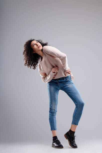 istock Fashion model posing with hands on her hips and looking up 2173482335