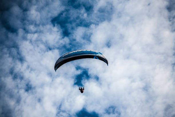istock Paraglider among the clouds in the blue sky 2173488134
