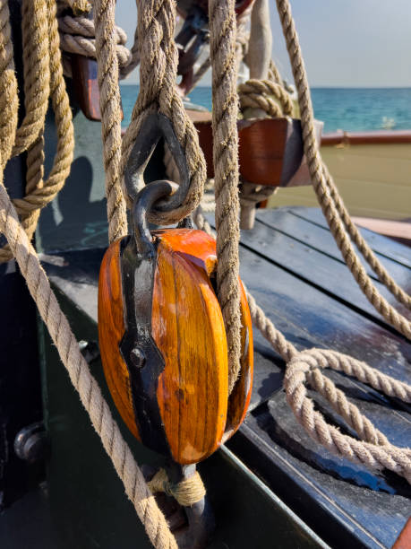 An old sailing freighter anchored in Düsseldorf. Sail, knots  and mast details from this old, historic, wooden sailing ship.