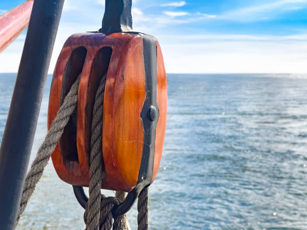 White Rope Linked Together On Wooden Ship Deck With Sunlight - Strength In Partnership Concept
