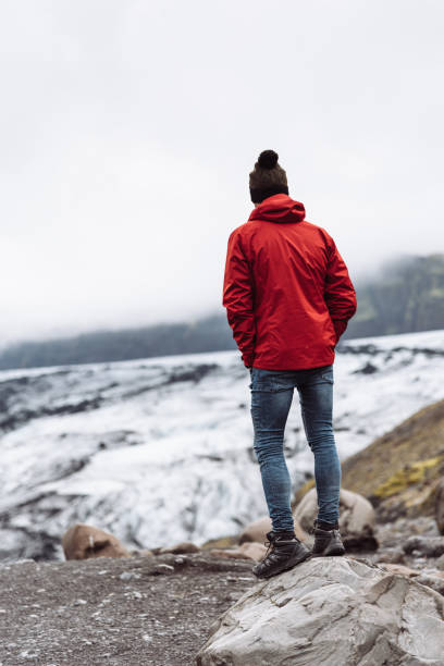 istock man standing on a glacier in iceland 2173492802