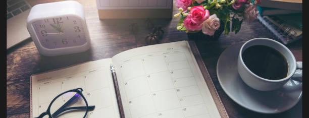 istock Planner and Concept.Desktop Calender 2025, cup of coffee place on office desk, working space. Notebook for Planner to make timetable agenda,appointment and agenda each date, month and year-banner image. 2173493389