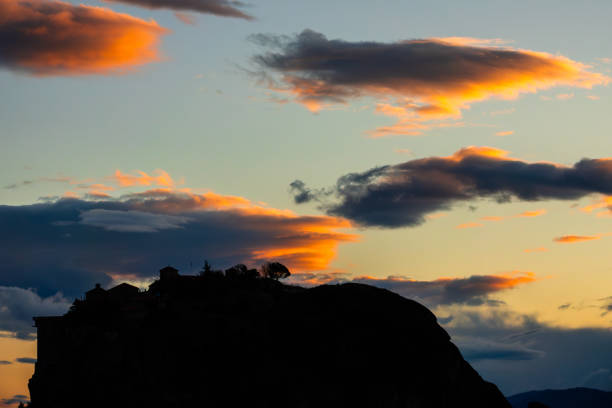 Northern Greece. Evening in the mountains of Thessaly. Amazing clouds over the silhouette of the Greek rock monastery in Meteora