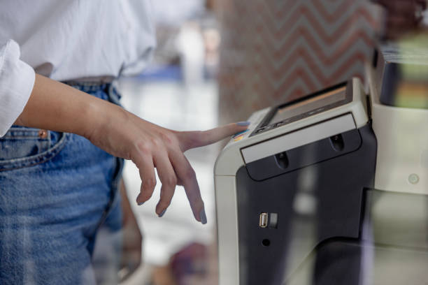istock Businesswoman's Hand Pressing the Copy Machine Button in a Modern Office, Reflections in the Window 2173494373