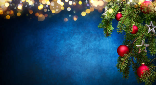 Christmas background with decorated fir branches and lights stock photo