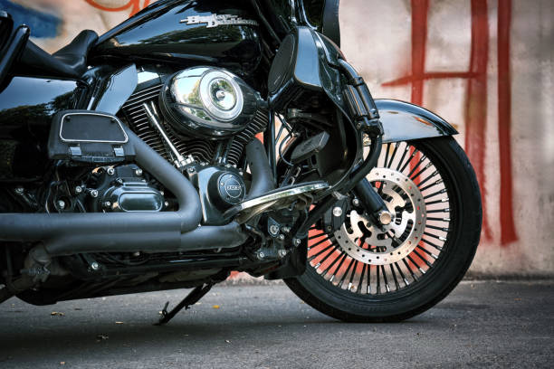 Close-up of a classic Harley-Davidson motorcycle with a black frame and an exhaust system on a city street: Tbilisi, Georgia - September 1, 2024.