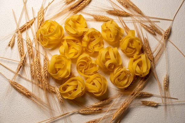 Wheat next to Tagliatelle Pasta on a rotating base