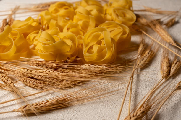 Wheat next to Tagliatelle Pasta on a rotating base