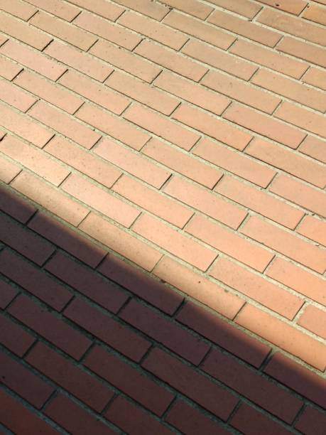 istock close up of a brick wall under the shadow 2173497726