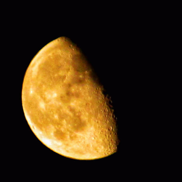 A close-up of the beautiful golden moon shining brightly in the night sky