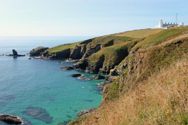 Housel Cove and Lizard Lighthouse on Bumble Rock, on the Lizard Peninsula, Cornwall, UK.
