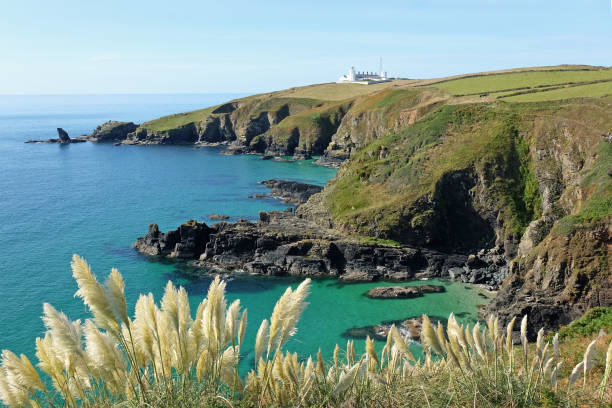 Housel Cove and Lizard Lighthouse on Bumble Rock, on the Lizard Peninsula, Cornwall, UK.