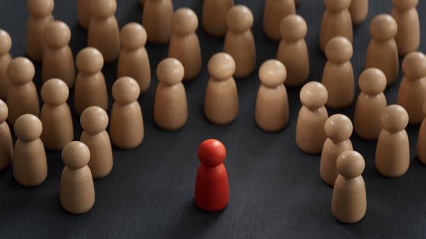istock Discrimination and inclusion concept. The wooden figurines surrounded the red one.3D rendering on black background. 2173501893