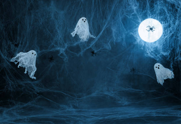 Halloween dark blue background with cobwebs, ghosts and a glowing moon. Image for montage or display your products with copy space.