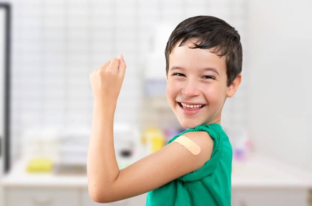 istock smiling kid with band aid after vaccination 2173508408