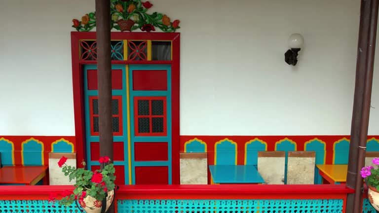 Man walking by a colorful colonial house in Jardin, Antioquia, Colombia