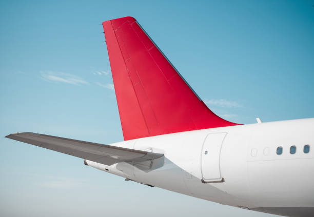 istock Empennage of white airplane with red vertical stabilizer. 2173510110