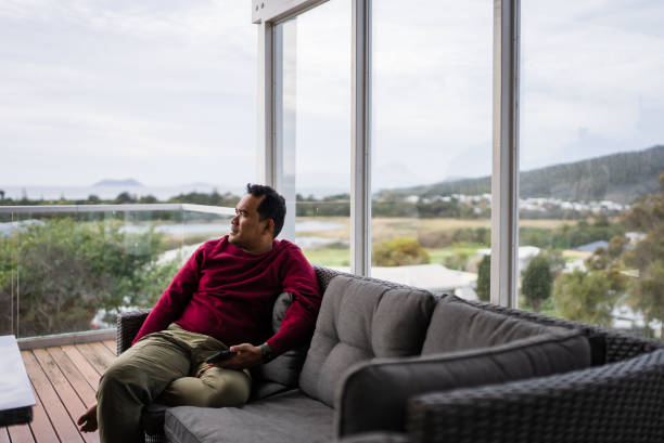 istock Thoughtful man sitting on armchair in balcony 2173510721