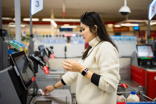 istock Female checkout by automatic payment machine in supermarket 2173510748