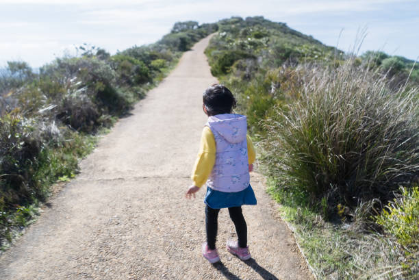 istock little girl exploring nature in sunny day 2173511063