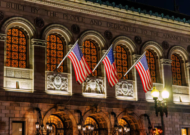Boston, Massachusetts, USA - September 16, 2024: Close-up of the Boston Public Library McKim Building at night in Copley Square. The library was established in 1848. Located in Boston's Back Bay neighborhood. The McKim Building houses the library's research collection, exhibition rooms, and administration offices.