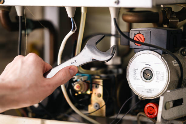 istock A man is repairing a water-heating boiler. 2173529565