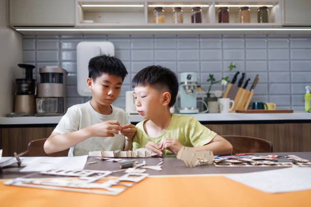 istock The two brothers are playing assembling models at home 2173532495