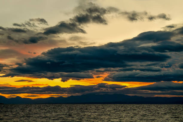 Bright clouds at sunset and waves