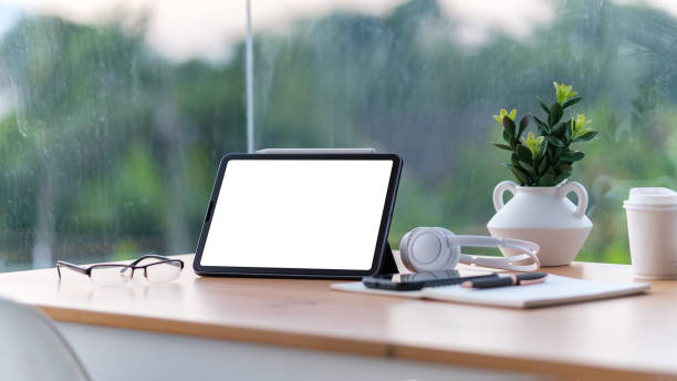 istock Serene home office with blank digital tablet screen on a wooden desk, ready for customization. 2173535418
