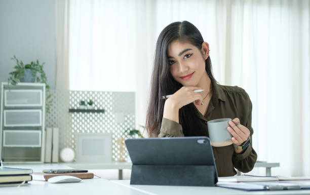 istock Successful businesswoman working with digital tablet at modern workspace. 2173535485
