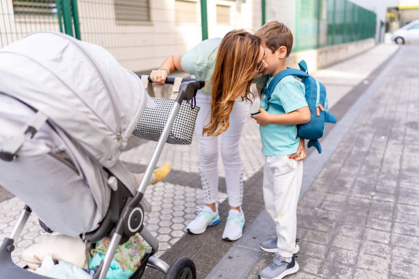 istock Mother kissing her son going to first day at school 2173535529