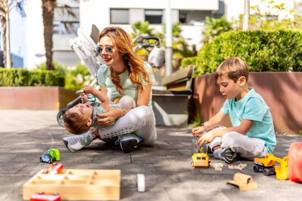 istock Playful mother and sons having fun in a park 2173535669