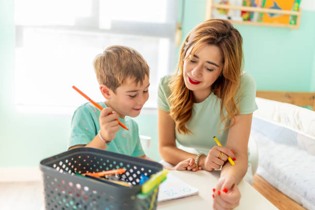 istock Boy and his mother coloring at home together 2173535736