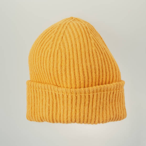 istock Bright orange knitted hat close-up. A warm and stylish accessory with an expressive texture, ideal for the cold 2173537040
