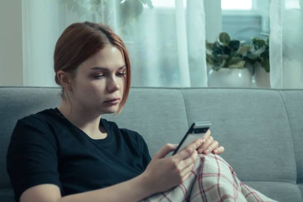 istock The girl is procrastinating: lying with a phone in her hands, a lazy expression on her face, a concentrated look 2173538493