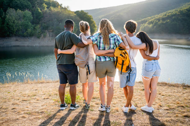 istock Friends embracing while standing in front of a lake 2173548110