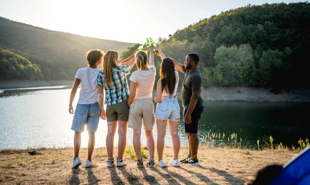 istock Friends toasting in front of a lake 2173550771