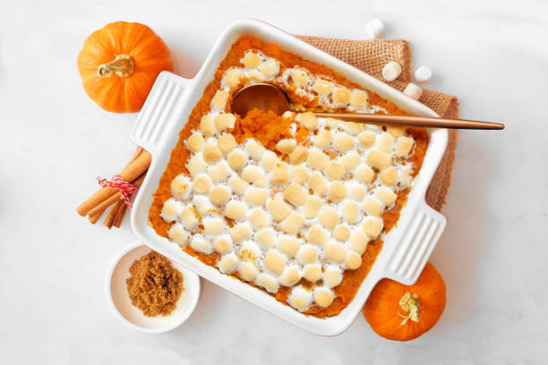 istock Sweet potato casserole with toasted marshmallows. Table scene on a white marble background. 2173555524
