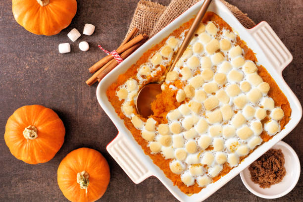 istock Sweet potato casserole with toasted marshmallows. Top down view table scene on a dark background. 2173555529