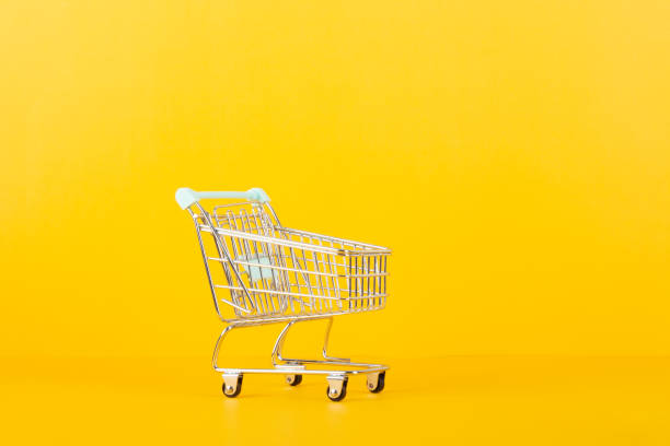 istock Empty shopping cart isolated on yellow background. purchase concept. 2173555697