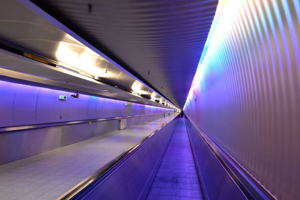 istock Futuristic Tunnel with Colorful Lighting and Automated Moving Walkway 2173556383
