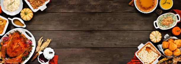 istock Traditional Thanksgiving turkey dinner double border on a rustic dark wood banner background 2173558246