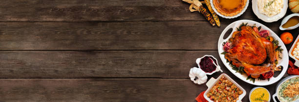 istock Traditional Thanksgiving turkey dinner side border on a rustic dark wood banner background 2173558248