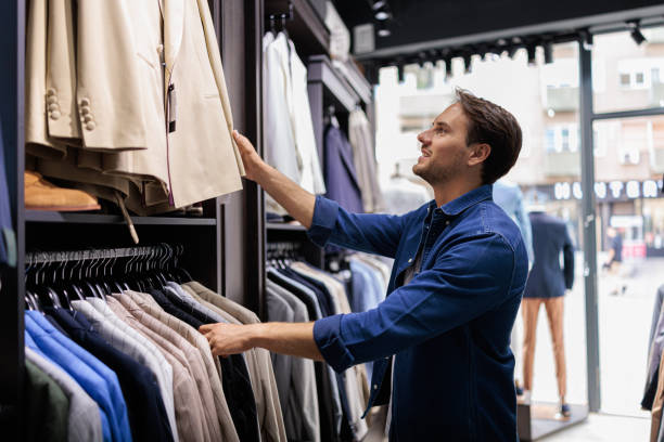 istock Handsome man at clothing store looking for a suit 2173563388
