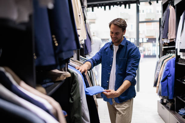 istock Handsome man at clothing store looking for a suit 2173563417
