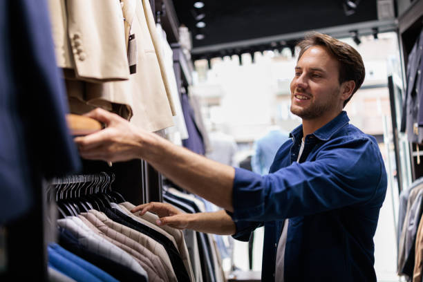 istock Handsome man at clothing store looking for a suit 2173563419